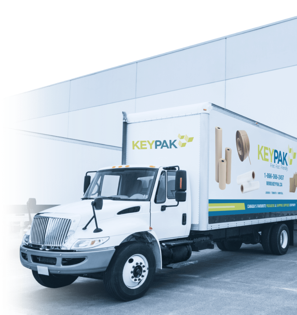 A white delivery truck with "KeyPak" branding is parked next to a building. Images of packaging materials and contact information are displayed on the side.